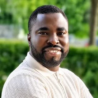 Portrait of Kunle Olutomilayo, PhD, Founder and CEO of ISIRO